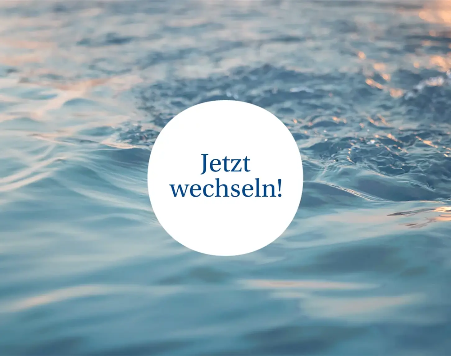 The evening sun is reflected in the surface of a body of water. The text in the picture says: "Switch now"